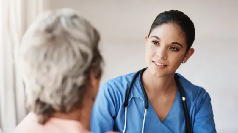 A registered nurse meeting with a patient.