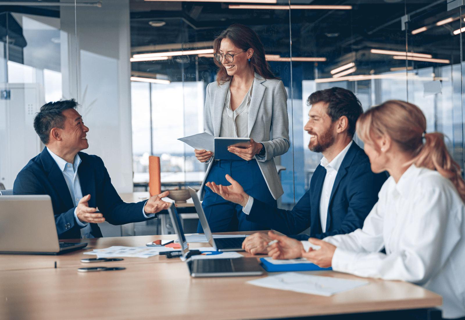 Group of professionals laughing in a meeting.