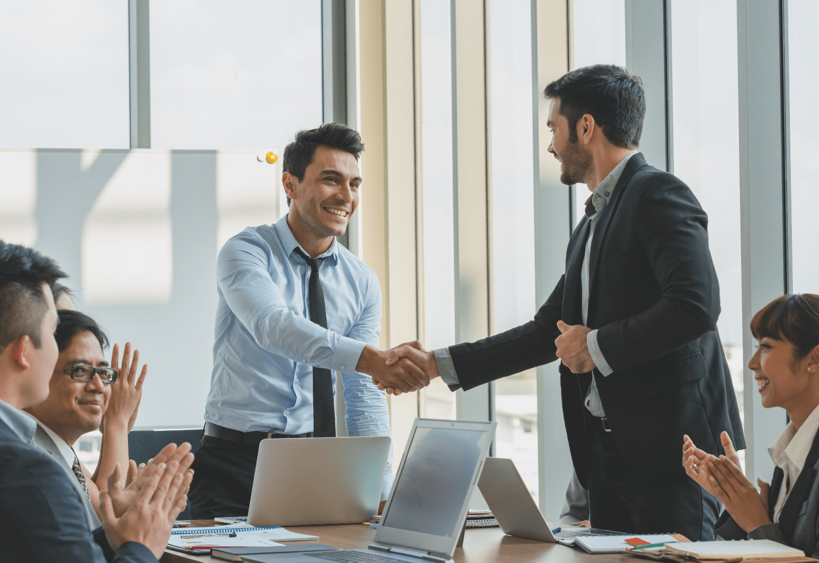 A job applicant finishing up a presentation with a potential employer.