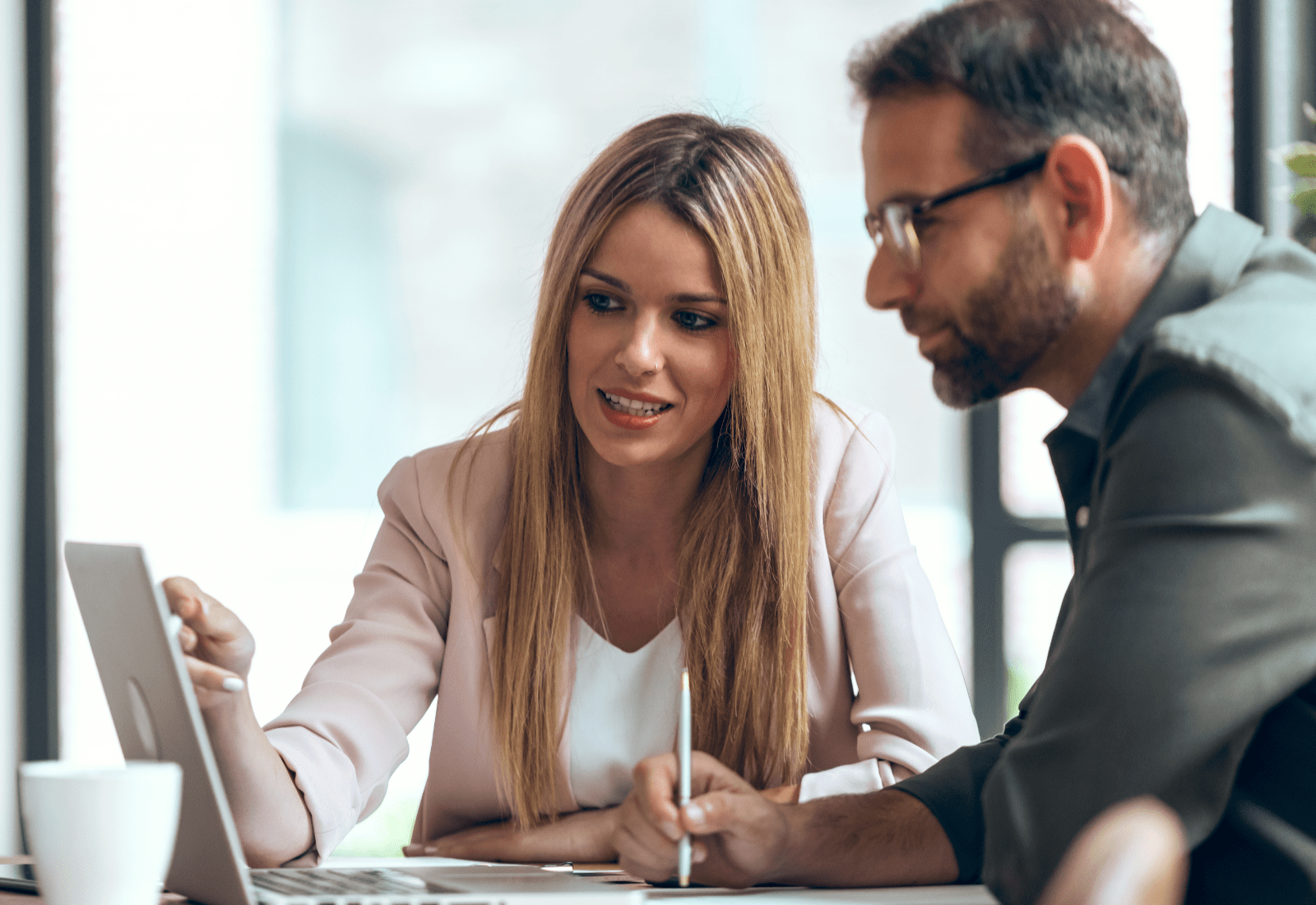 A male and female employee discussing a work initiative.