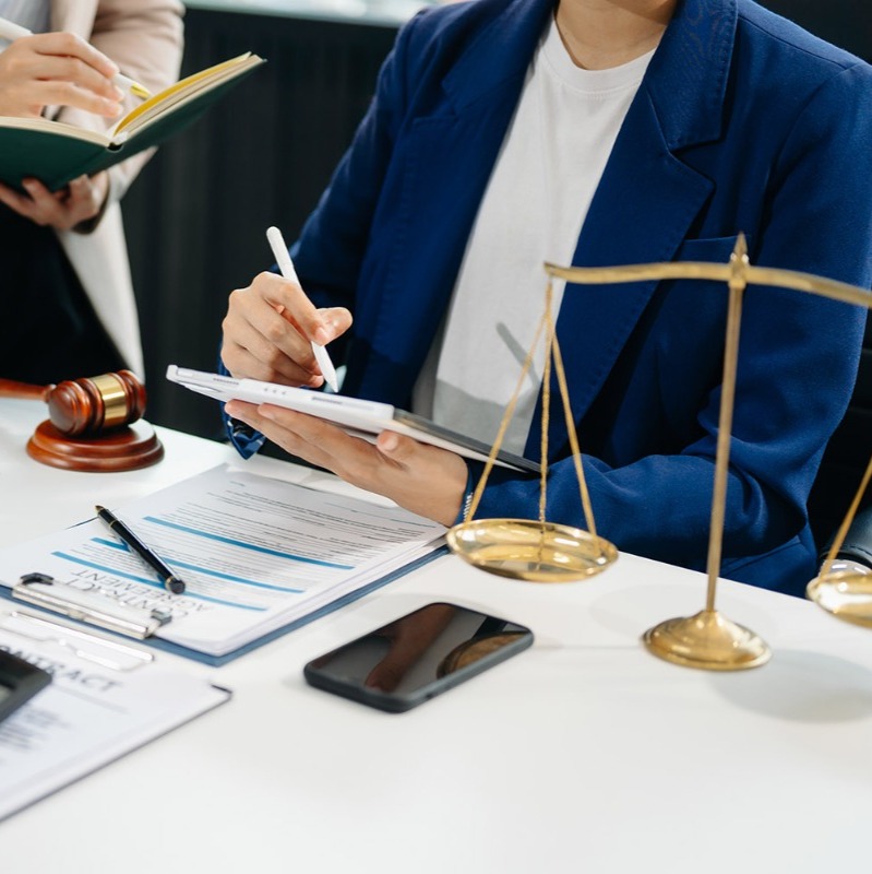 A finance or legal consultant sits at a desk